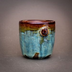 a small cup with a blue, shifting color